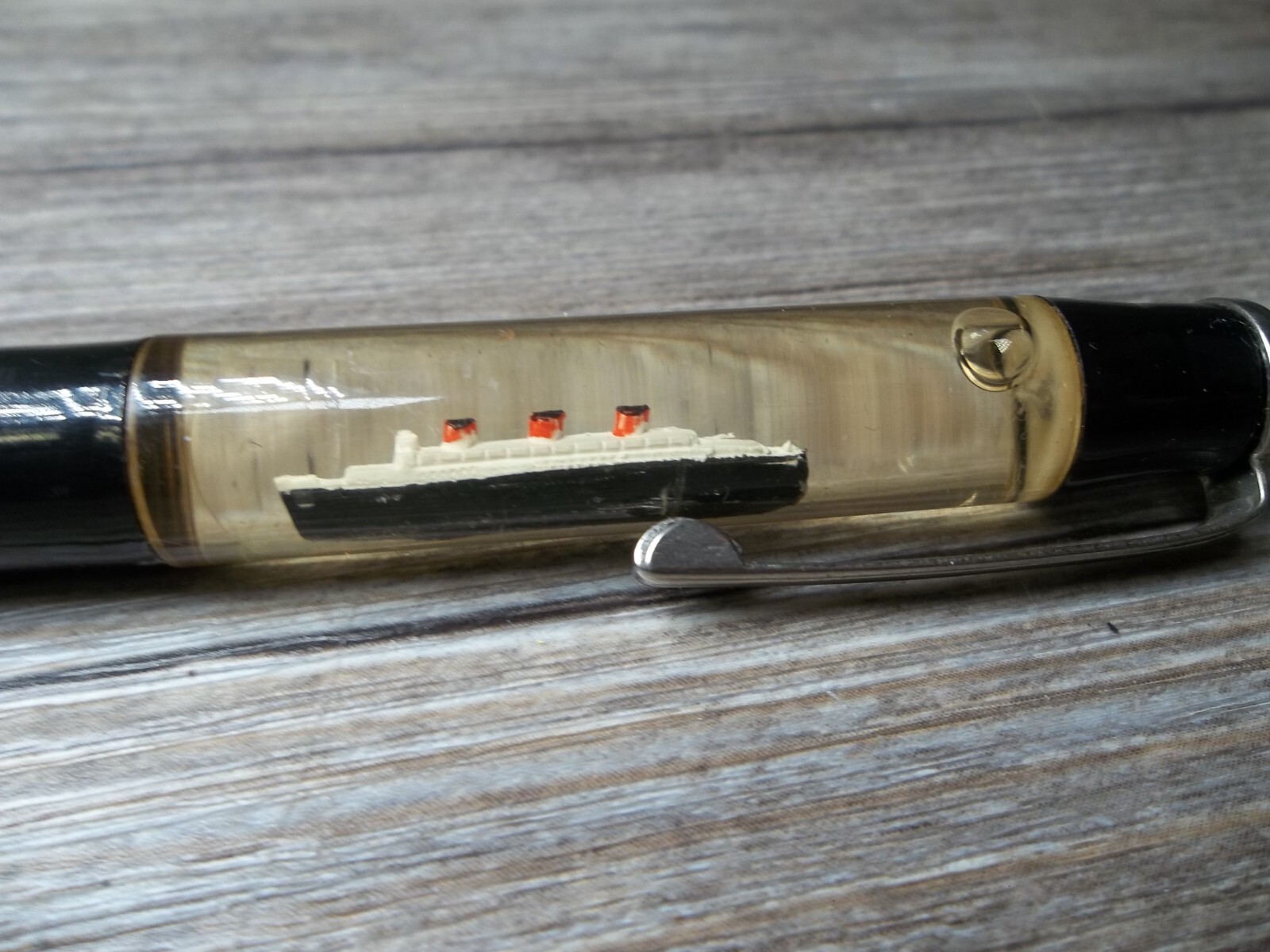 R.M.S. “Queen Mary” ship floating in oil in top of mechanical pencil neat Z4