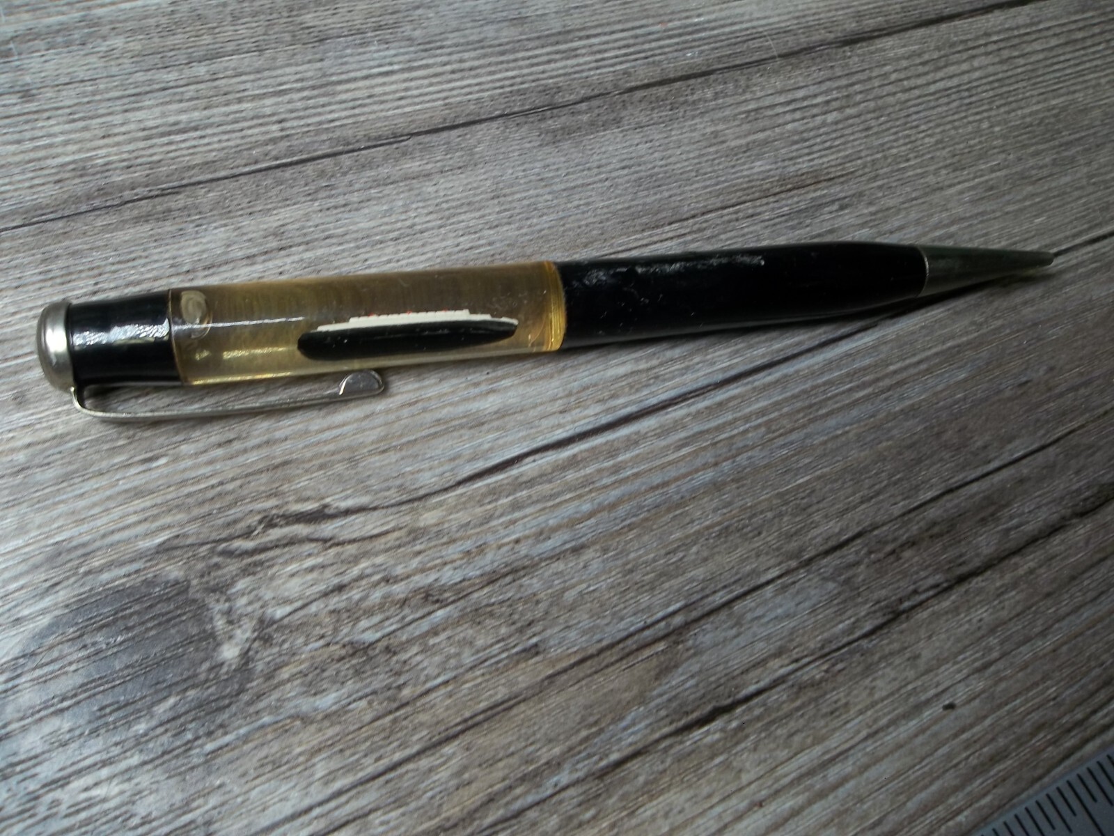 R.M.S. “Queen Mary” ship floating in oil in top of mechanical pencil neat Z4