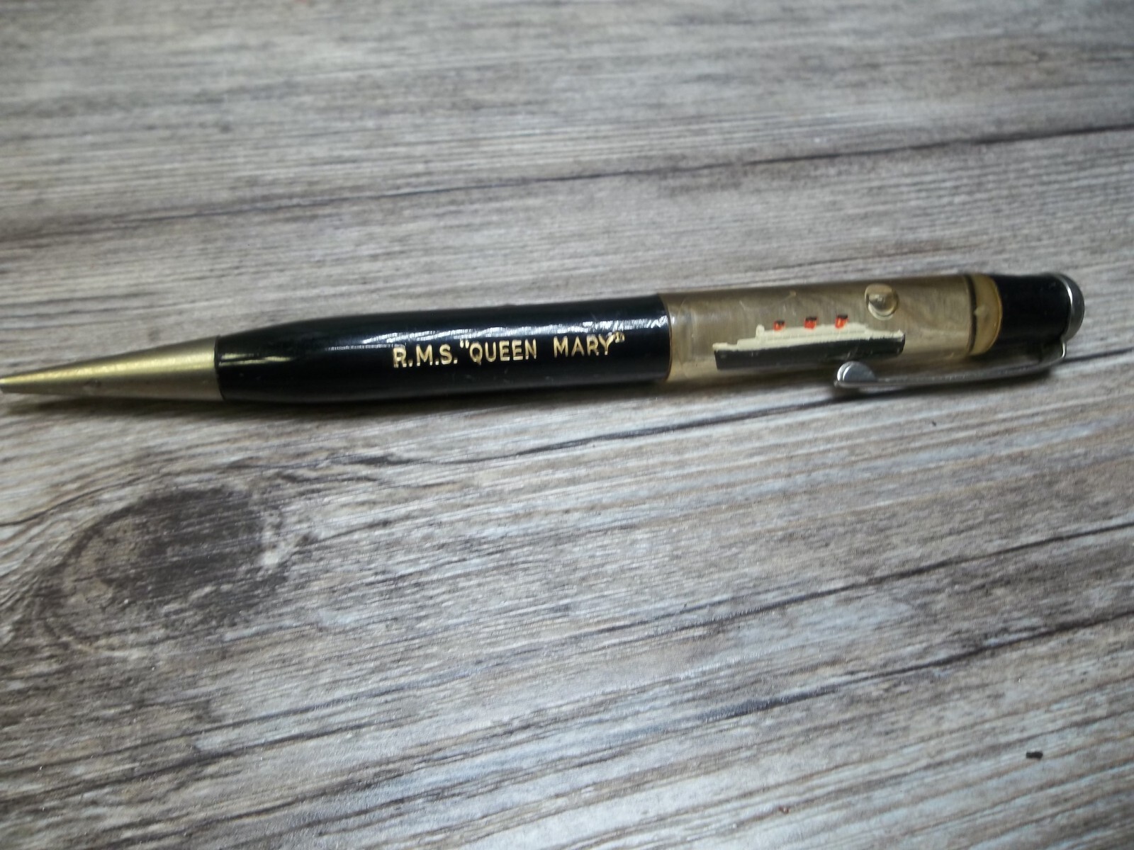 R.M.S. “Queen Mary” ship floating in oil in top of mechanical pencil neat Z4