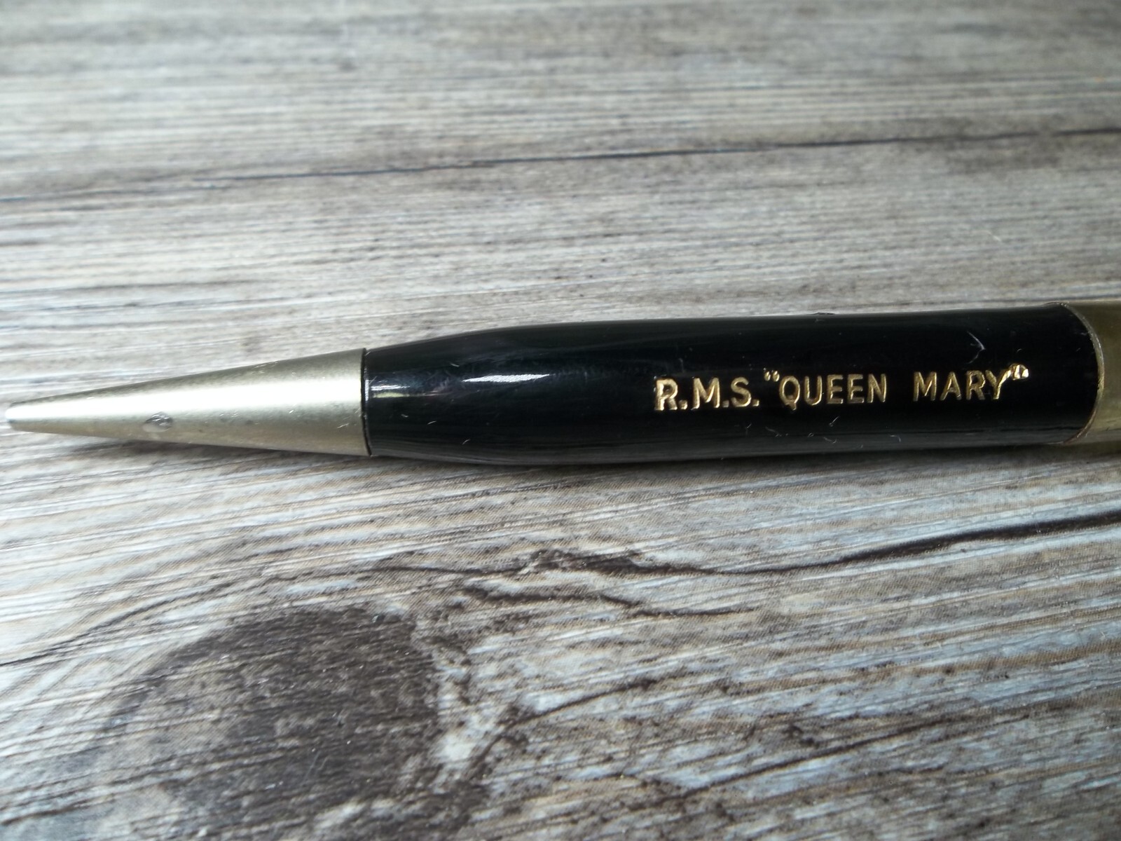 R.M.S. “Queen Mary” ship floating in oil in top of mechanical pencil neat Z4