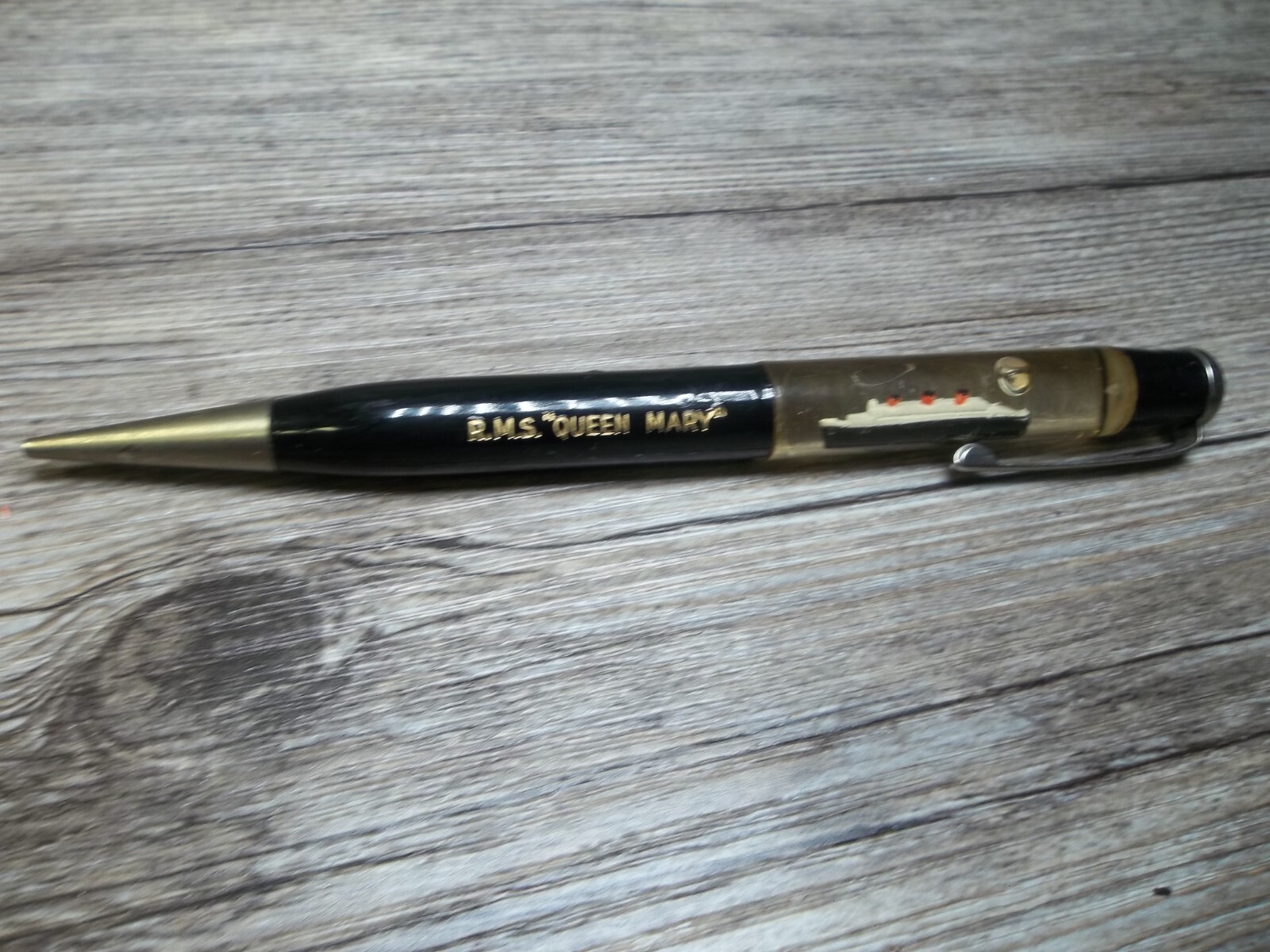 R.M.S. “Queen Mary” ship floating in oil in top of mechanical pencil neat Z4